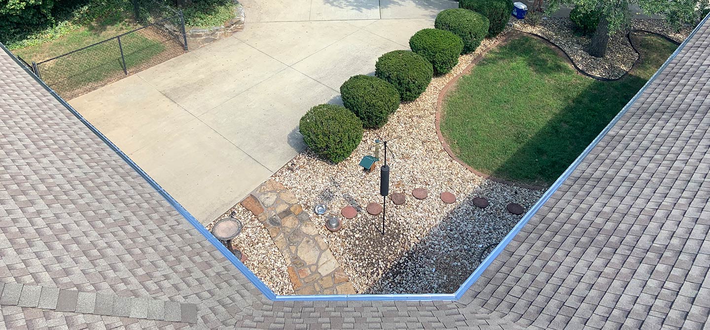 view from above of roof gutters and front lawn and driveway